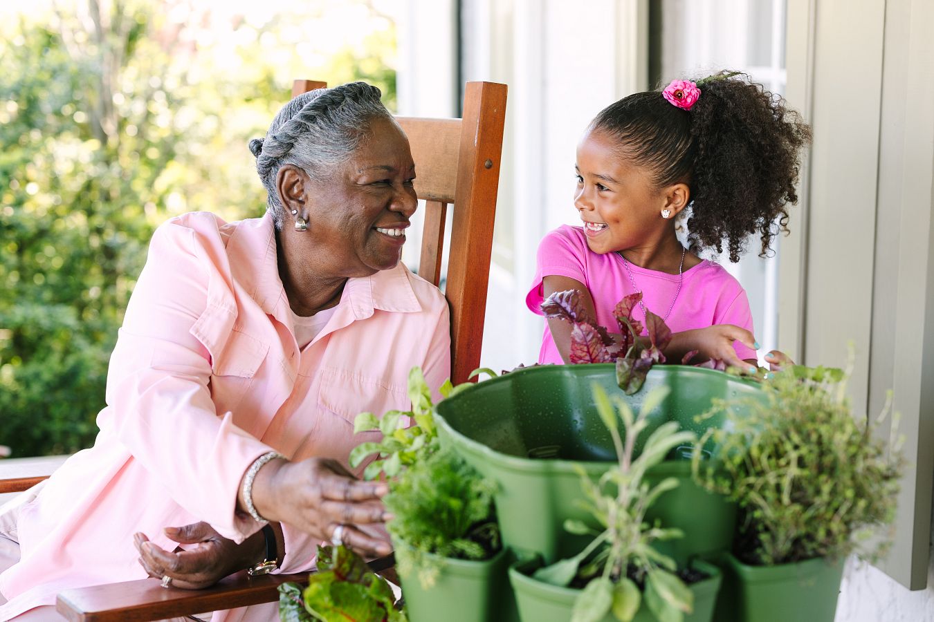 Grandmother gardening with her grand daughter