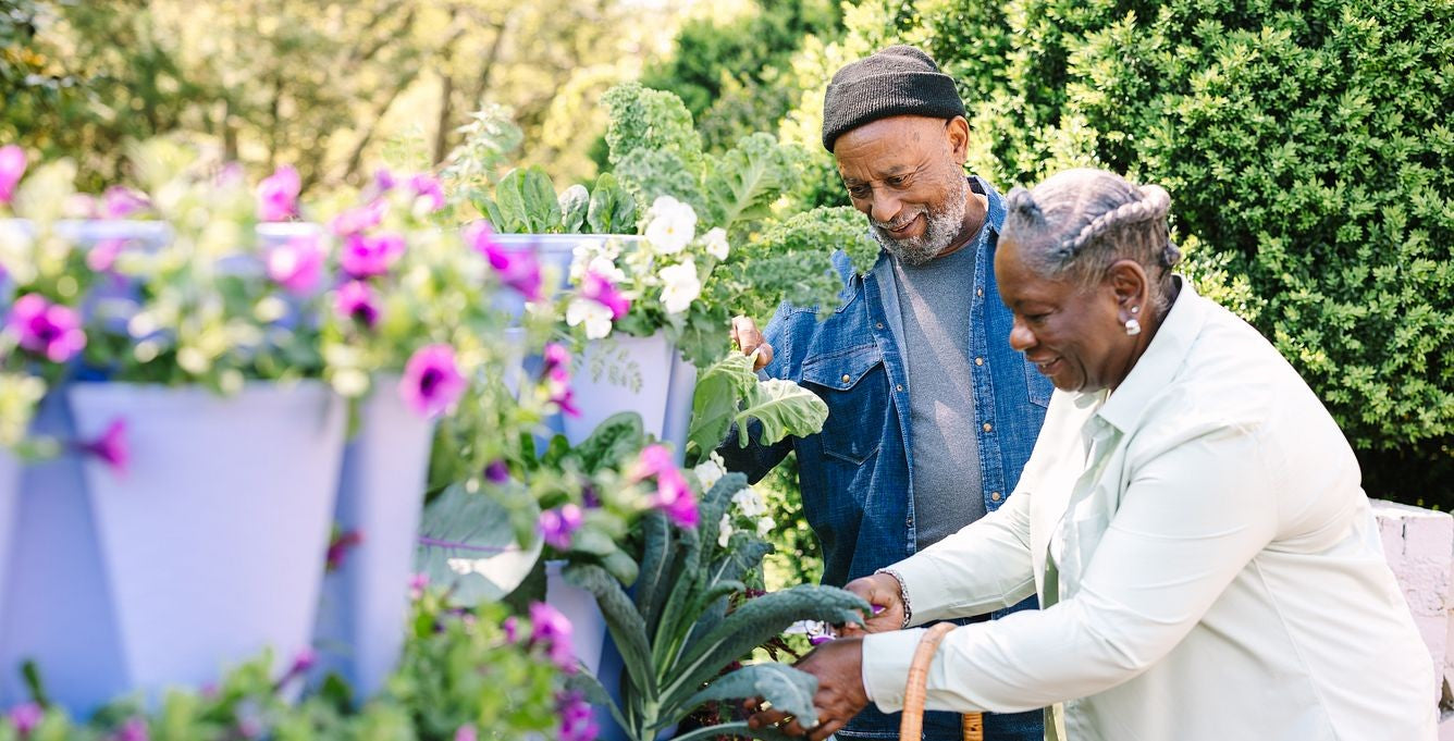 Couple harvesting from a GreenStalk