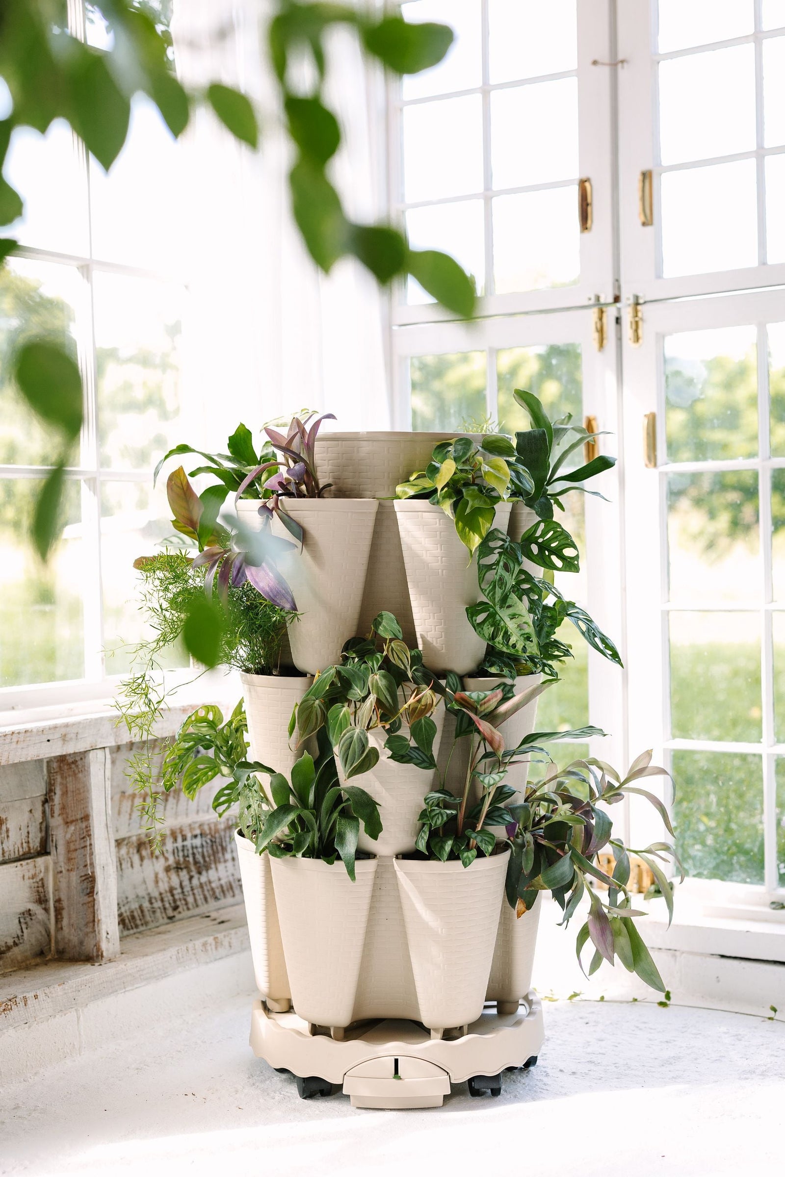 A 3-Tier GreenStalk Vertical Planter with various houseplants